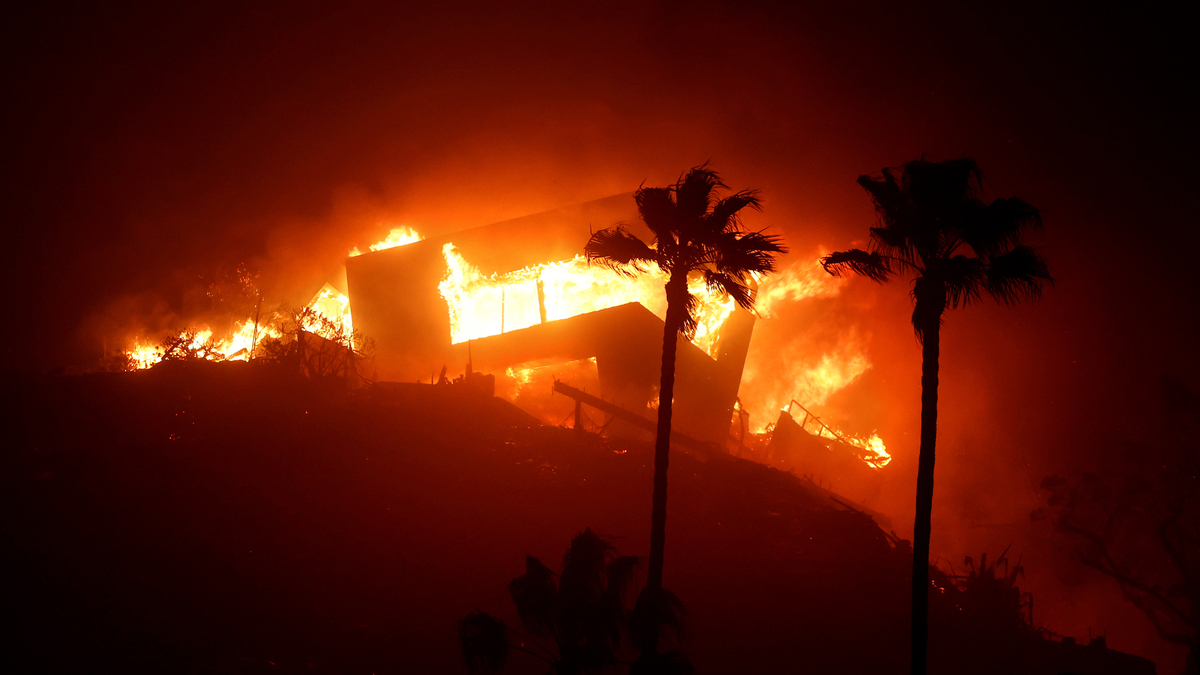 A house along Pacific Coast Highway in Malibu burns in the Palisades fire in January 2025. (Wally Skalij/Los Angeles Times)