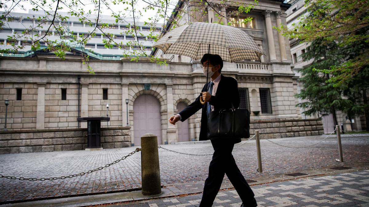 An office employee walks in front of the bank of Japan building in Tokyo, Japan, April 7, 2023. REUTERS/Androniki Christodoulou