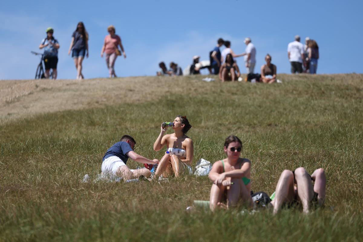  People sunbathing on Primrose Hill in London, England, in July 2022. 