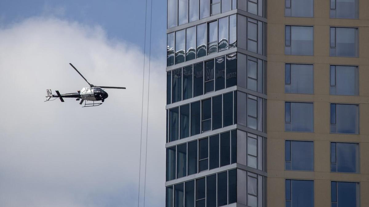 Los Angeles, CA - April 20: A Los Angeles Police helicopter flies over downtown Los Angeles Wednesday, April 20, 2022. Los Angeles Mayor Eric Garcetti called Wednesday for an 8.5% increase in the Police Departments operating budget, providing a major boost to overtime pay while also seeking to fill hundreds of vacant positions. Garcetti released his $11.8-billion budget for the coming year, which would increase the LAPDs operating budget by $149 million and take LAPD staffing up to 9,735 police officers by mid-2023, an increase of 29 positions compared with this years budget.(Allen J. Schaben / Los Angeles Times)