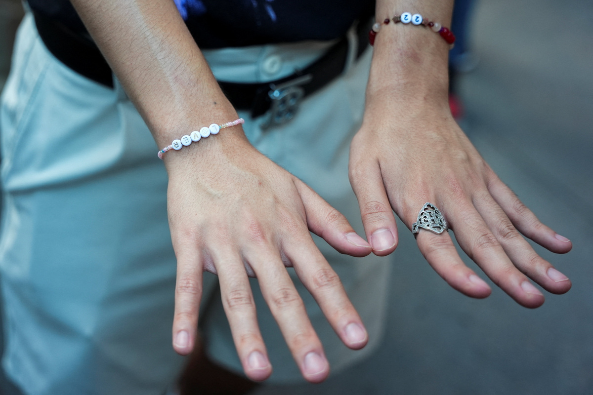 A Taylor Swift fan wears friendship bracelets outside of Madison Square Garden, the venue for the reported wedding celebrations of singer Taylor Swift and National Football League (NFL) player Travis Kelce, in New York, U.S., July 3, 2026.  REUTERS/Angelina Katsanis