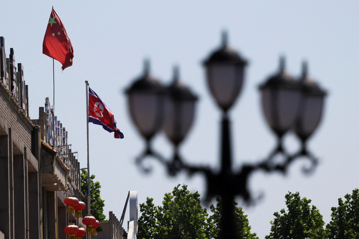 A Chinese flag flutters near a North Korean flag at the North Korea consular office in Dandong, Liaoning province, China June 8, 2026. REUTERS/Maxim Shemetov