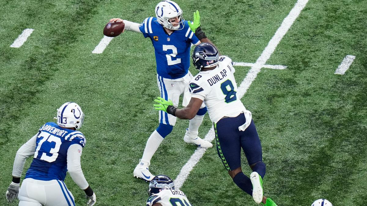 Indianapolis Colts quarterback Carson Wentz (2) is pressured by Seattle Seahawks defensive end Carlos Dunlap (8) during the second half of an NFL football game in Indianapolis, Sunday, Sept. 12, 2021. (AP Photo/AJ Mast)