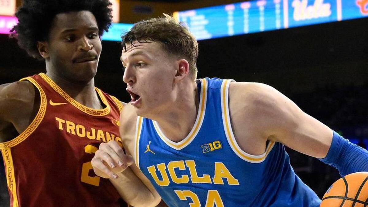  Feb 24, 2026; Los Angeles, California, USA; UCLA Bruins forward Tyler Bilodeau (34) drives to the basket defended by Southern California Trojans forward Ezra Ausar (2) during the second half at Pauley Pavilion presented by Wescom Financial. Mandatory Credit: Robert Hanashiro-Imagn Images | Robert Hanashiro-Imagn Images 