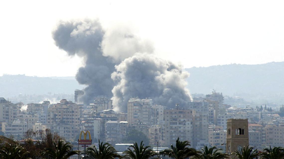 Smoke rises behind palm trees and a McDonald's "Golden Arches" logo from the site of an Israeli airstrike that targeted the Al-Hosh area near the coastal Lebanese city of Tyre on April 14, 2026. Lebanon is launching talks with Israel days after the United States and Iran failed to reach an agreement to end the broader Middle East war. The two sides have declared a two-week truce that Iran and mediator Pakistan insist includes Lebanon, but which Israel and Washington have said does not. Beirut says 2,089 people have been killed, including 166 children and 88 healthcare workers, since the war spread to Lebanon on March 2. (Kawnat Haju/AFP via Getty Images/TNS)