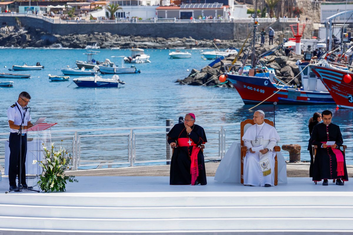 Pope Leo XIV listens as Tito Villarmea Captain of Guardamar Urania rescue boat speaks during a meeting with organizations working with migrants at the Port of Arguineguin, during his apostolic journey on the island of Gran Canaria, Spain June 11, 2026. REUTERS/Borja Suarez