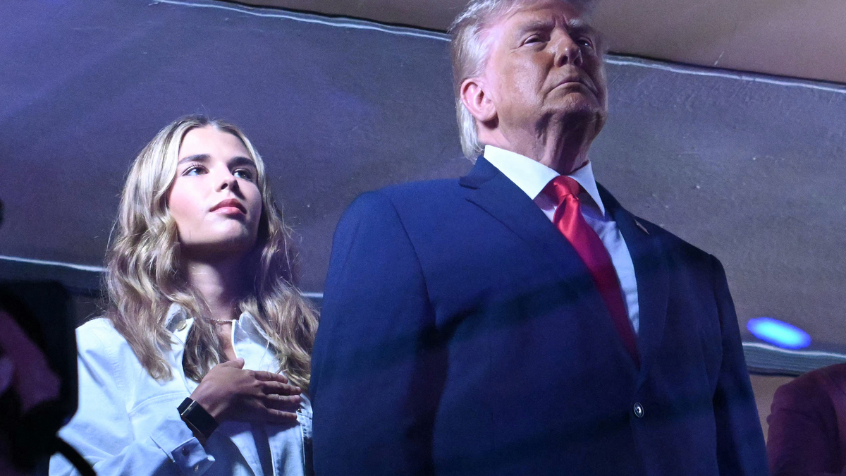 Kai Trump and her grandfather U.S. President Donald Trump stand during the National Anthem as they attend Game Three of the NBA Finals between the San Antonio Spurs and the New York Knicks at Madison Square Garden in New York on June 8, 2026. (Saul Loeb/AFP via Getty Images/TNS)