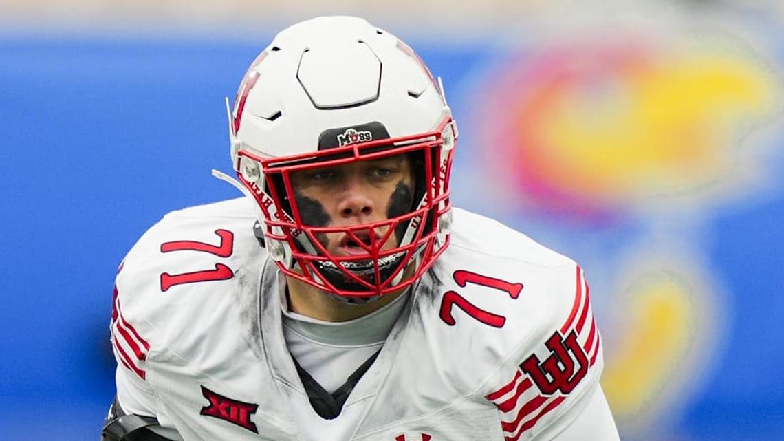  Nov 28, 2025; Lawrence, Kansas, USA; Utah Utes offensive lineman Caleb Lomu (71) gets ready before the snap during the second half against the Kansas Jayhawks at David Booth Kansas Memorial Stadium. Mandatory Credit: Jay Biggerstaff-Imagn Images | Jay Biggerstaff-Imagn Images 