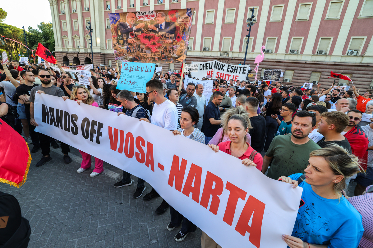  TIRANA, ALBANIA – JUNE 2: Protesters gather under the slogan “Albania is not for sale”, asking for the resignation of Albanian Prime Minister Edi Rama, in front of Albanian Government building on June 2, 2026 in Tirana, Albania. Recently protests have escalated into violent clashes over illegal bulldozing in the protected PishÎ Poro-Narta landscape, sparking solidarity rallies in Tirana. This environmental destruction is driven by the government’s push for luxury tourism developments and has drawn severe backlash from the European Union. The European Commission is actively monitoring the crisis, explicitly warning Tirana that failing to halt this habitat destruction and ignoring environmental regulations will directly jeopardise Albania’s EU accession process under Chapter 27 (Environment). (Photo by Armando Babani/Getty Images) 