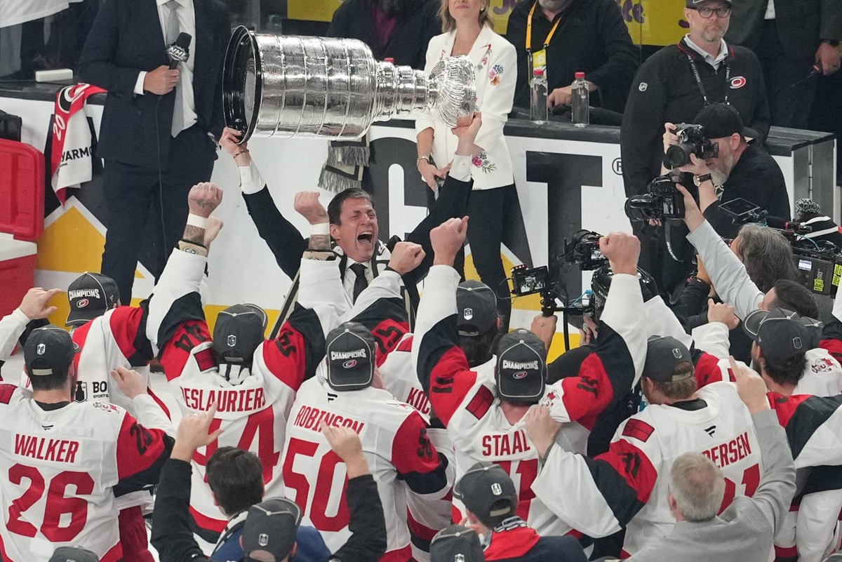  Carolina Hurricanes head coach Rod Brind'Amour celebrates holding the Stanley Cup after the win against the Vegas Golden Knights in game six of the 2026 Stanley Cup Final at T-Mobile Arena. Mandatory Credit: Lucas Peltier-Imagn Images