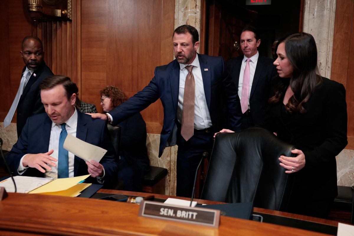 U.S. Homeland Security Secretary Markwayne Mullin greets Sen. Chris Murphy (D-CT), left, and Sen. Katie Britt (R-AL), right, as he arrives to testify before a Senate Appropriations Homeland Security Subcommittee hearing on the president's proposed FY2027 budget request for the Department of Homeland Security, on Capitol Hill in Washington, D.C., U.S., June 2, 2026. REUTERS/Evan Vucci