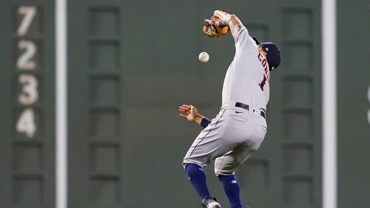 Houston Astros shortstop Carlos Correa drops a pop fly by Boston Red Sox’s Rafael Devers who was ruled out due to the infield fly rule in the sixth inning of a baseball game at Fenway Park, Thursday, June 10, 2021, in Boston. (AP Photo/Elise Amendola)