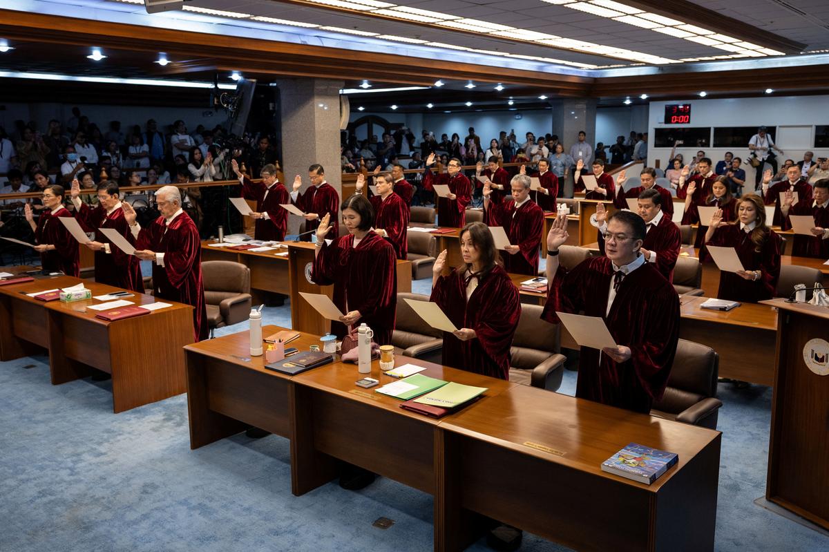 Philippine senators take oath as they convene as an impeachment court to hear the case of Vice President Sara Duterte, at the Senate in Pasay City, Philippines, May 18, 2026. REUTERS/Eloisa Lopez