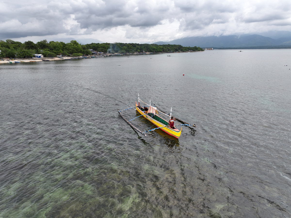 A drone view shows 59-year-old fisherman Rony Drio aboard a small fishing boat in San Salvador, Masinloc, Zambales province, Philippines, July 8, 2026. REUTERS/Adrian Portugal