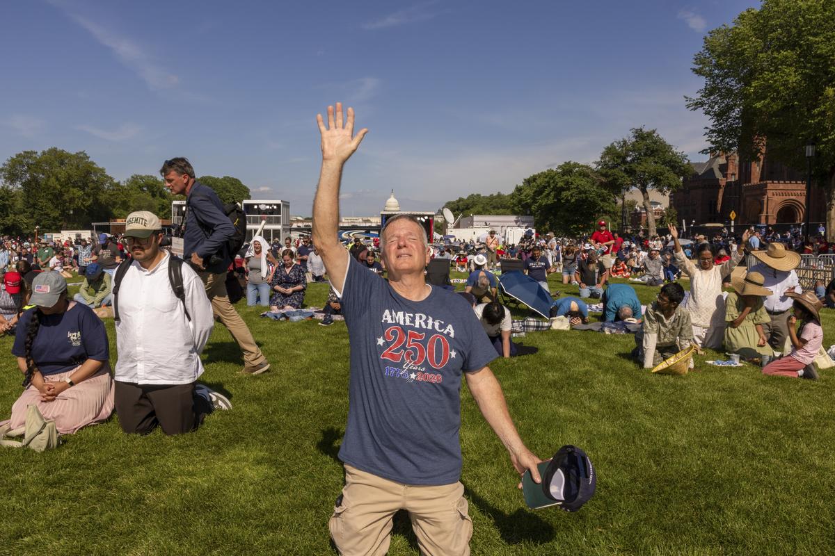 An attendee prays at Rededicate 250: A National Jubilee of Prayer, Praise & Thanksgiving, in Washington on Sunday, May 17, 2026. Thousands of people gathered on the National Mall on Sunday for a daylong rally blending Christian prayer and political fervor, a gathering President Donald Trump had touted as an opportunity to "rededicate America as one nation under God." (Alex Kent/The New York Times)
