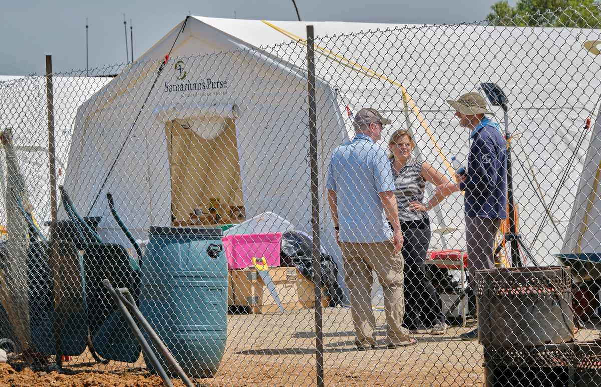 Workers from the Samaritan's Purse International Relief stand by a tent, as they set up an Ebola response facility at the Scott Powell Memorial Ebola Treatment Center, as aid agencies intensify efforts to contain the Ebola outbreak caused by the Bundibugyo virus, in Bunia town, Ituri province, Democratic Republic of Congo, June 11, 2026. REUTERS/Gradel Muyisa Mumbere