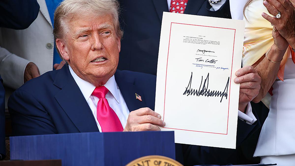 President Donald Trump, joined by Republican lawmakers, signs the One, Big Beautiful Bill Act into law during an Independence Day military family picnic on the South Lawn of the White House on July 4, 2025, in Washington, D.C.