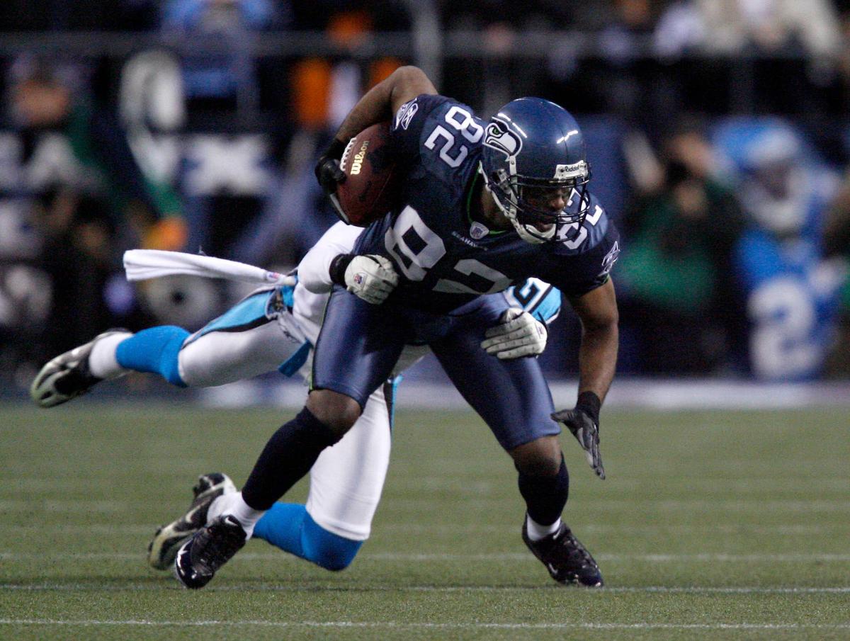  Seattle Seahawks wide receiver Darrell Jackson tries to elude the tackle of a Carolina Panthers defender during the NFC Championship at Qwest Field. Bob Donnan-USA TODAY Sports