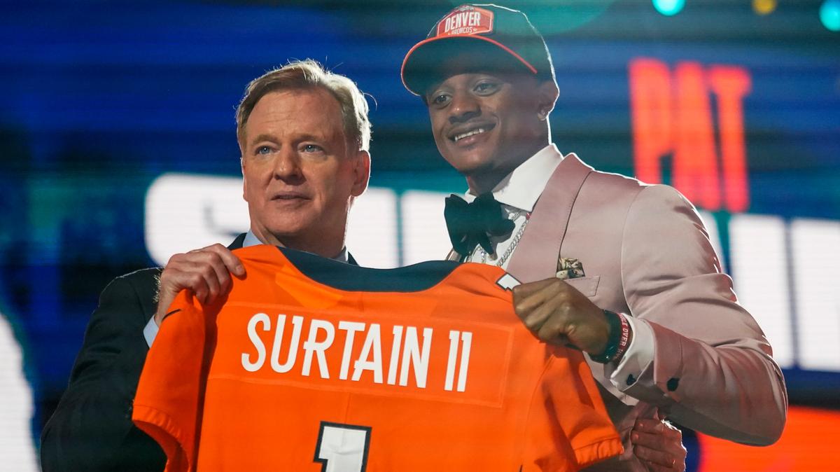 Alabama cornerback Patrick Surtain II, right, holds a team jersey with NFL Commissioner Roger Goodell after he was chosen by the Denver Broncos with the ninth pick in the NFL football draft, Thursday, April 29, 2021, in Cleveland. (AP Photo/Tony Dejak)