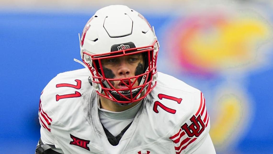  Nov 28, 2025; Lawrence, Kansas, USA; Utah Utes offensive lineman Caleb Lomu (71) gets ready before the snap during the second half against the Kansas Jayhawks at David Booth Kansas Memorial Stadium. Mandatory Credit: Jay Biggerstaff-Imagn Images | Jay Biggerstaff-Imagn Images 