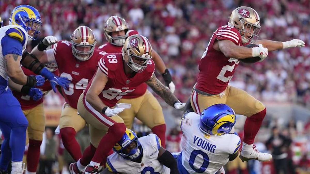  Nov 9, 2025; Santa Clara, California, USA; San Francisco 49ers running back Christian McCaffrey (23) runs the ball against Los Angeles Rams linebacker Byron Young (0) during the second quarter at Levi's Stadium. Mandatory Credit: Kyle Terada-Imagn Images | Kyle Terada-Imagn Images 