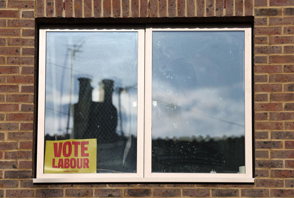 A sign supporting the Labour Party political party is displayed in a house window on the eve of local and mayoral elections in England and devolved parliamentary elections in Wales and Scotland on May 7, in London, Britain, May 6, 2026. REUTERS/Toby Melville