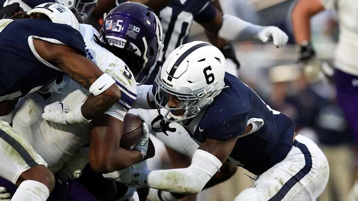  Oct 11, 2025; University Park, Pennsylvania, USA; Penn State Nittany Lions cornerback Audavion Collins (2) and safety Zakee Wheatley (6) tackle Northwestern Wildcats running back Caleb Komolafe (5) during the fourth quarter at Beaver Stadium. Mandatory Credit: Matthew O'Haren-Imagn Images | Matthew O'Haren-Imagn Images 