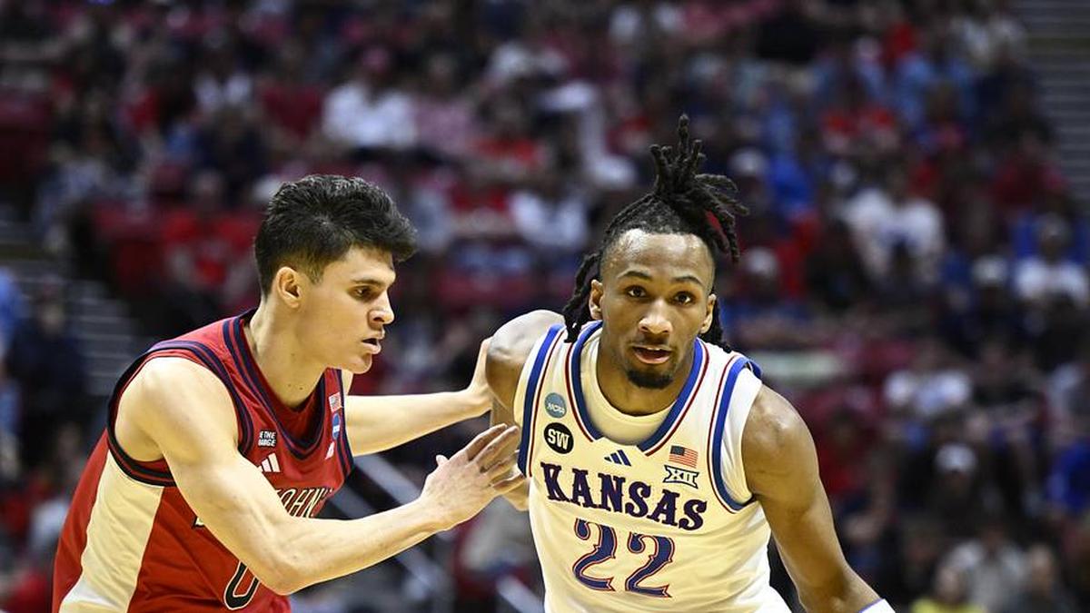  Mar 22, 2026; San Diego, CA, USA; Kansas Jayhawks guard Darryn Peterson (22) controls the ball against St. John's Red Storm guard Dylan Darling (0) in the first half during a second round game of the men's 2026 NCAA Tournament at Viejas Arena. Mandatory Credit: Denis Poroy-Imagn Images | Denis Poroy-Imagn Images 