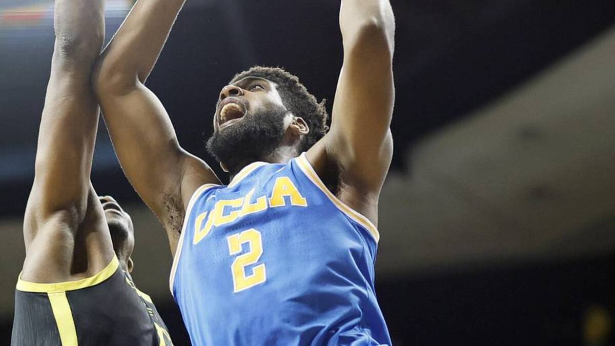  Feb 24, 2022; Eugene, Oregon, USA; UCLA Bruins forward Cody Riley (2) shoots under pressure from Oregon Ducks center N'Faly Dante (1) during the second half at Matthew Knight Arena. Mandatory Credit: Soobum Im-Imagn Images | Soobum Im-Imagn Images 