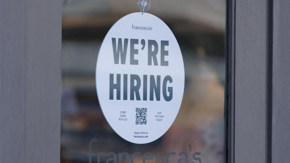 A "we're hiring" sign is displayed on the door of a local business, after U.S. employment growth slowed more than expected in July, in Encinitas, California, U.S. August 1, 2025.   REUTERS/Mike Blake