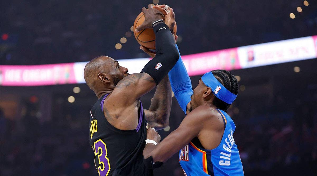  Los Angeles Lakers forward LeBron James (23) goes up for a basket as Oklahoma City Thunder guard Shai Gilgeous-Alexander (2) defends during the first quarter at Paycom Center. Alonzo Adams-Imagn Images