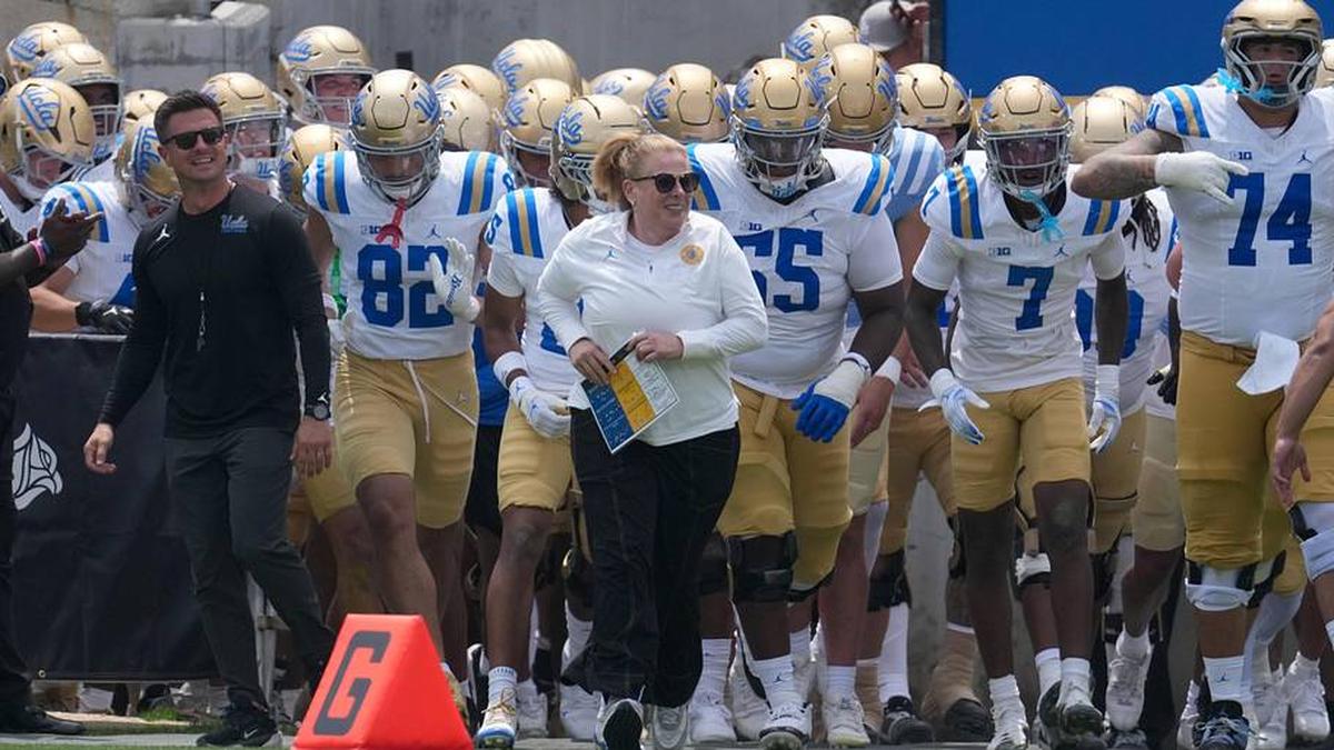  May 2, 2026; Pasadena, CA, USA; UCLA Bruins coach Bob Chesney and women's basketball coach Cori Close lead players onto the field during the spring game at Rose Bowl. Mandatory Credit: Kirby Lee-Imagn Images | Kirby Lee-Imagn Images 
