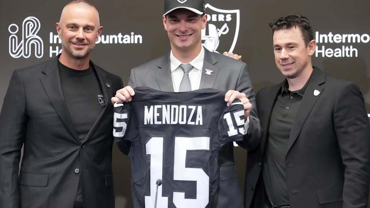  Apr 24, 2026; Henderson, NV, USA; Las Vegas Raiders quarterback Fernando Mendoza (center) poses with general manager John Spytek (left) and head coach Klint Kubiak at introductory press conference at Intermountain Health Performance Center after being selected as the No. 1 pick in the 2026 NFL Draft. Mandatory Credit: Kirby Lee-Imagn Images | Kirby Lee-Imagn Images 