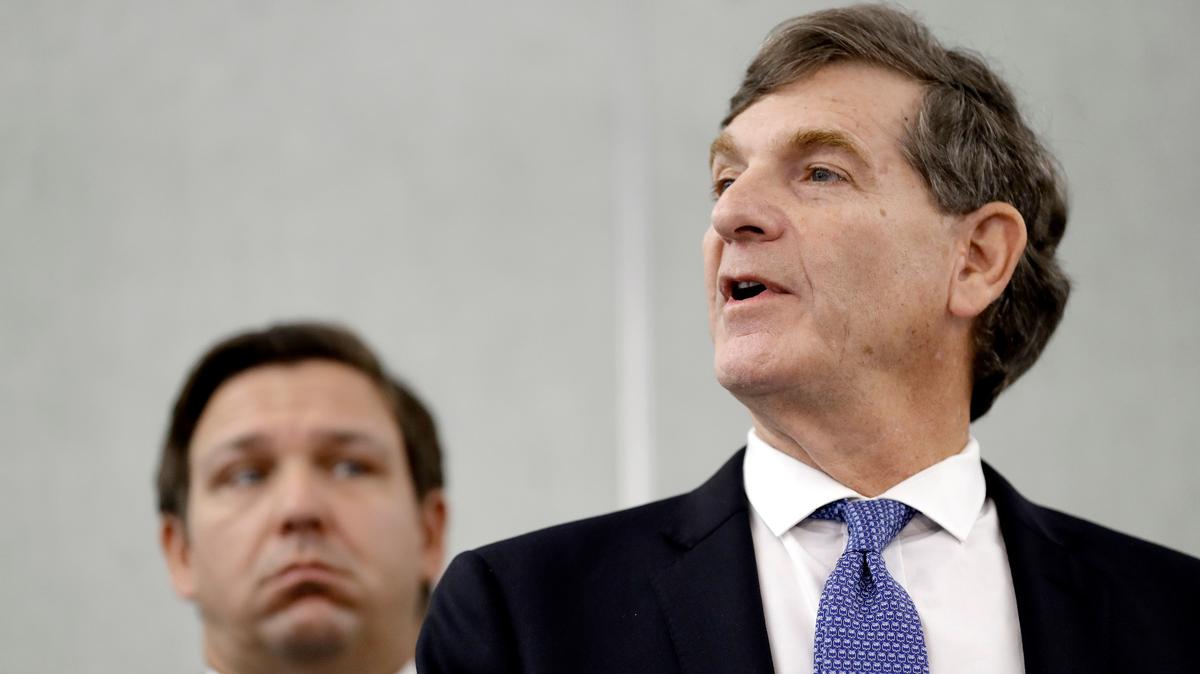 Former Florida Surgeon General Dr. Scott Rivkees speaks to the media as Florida Gov. Ron DeSantis looks on during a news conference Monday, March 2, 2020, in Tampa. Rivkees accepted a job at Brown University, Monday, Nov. 22, 2021, to work on the school’s pandemic preparedness.