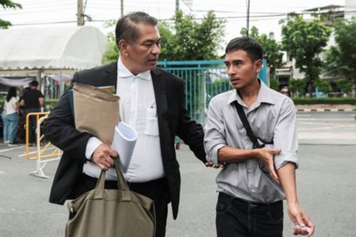 Noppadon Wongsuvan, 33, a Thai crew member of the cargo ship Mayuree Naree that was struck on March 11, killing three crew members, while sailing through the Strait of Hormuz, and his lawyer, Kunpat Singhathong, arrive at the Central Labour Court to file a lawsuit accusing Thailand-based company Precious Shipping of ordering the vessel to sail through the waterway despite military tensions between the U.S. and Iran, in Bangkok, Thailand, July 10, 2026. REUTERS/Chalinee Thirasupa