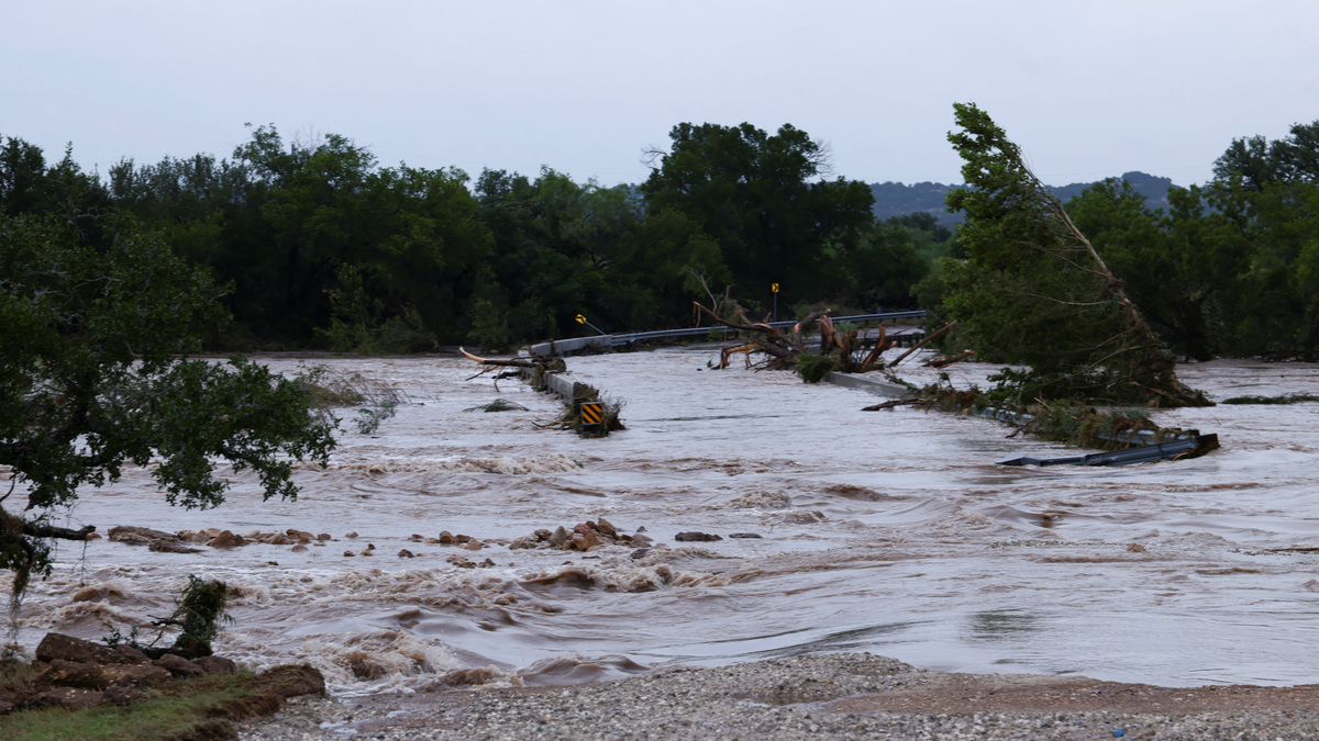 The Pedernales River rises over Old San Antonio Road as heavy rains and severe weather hit southern Texas near Fredericksburg on Thursday. Gov. Greg Abbott said that two people were killed after floodwaters swept them away in their vehicles.