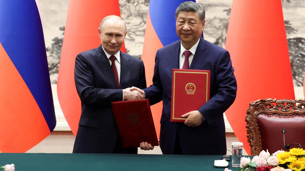 Russian President Vladimir Putin and Chinese President Xi Jinping shake hands during a signing ceremony at the Great Hall of the People in Beijing on Wednesday.