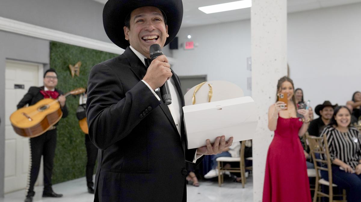 Latin Grammy winner and Democratic candidate for Texas' 15th Congressional District Bobby Pulido reacts as he opens the gift given to him by Julieta Judith Gonzalez's family during her quinceanera party on March 14, 2026 in Edinburg, Texas. (Gabriel V. Cardenas/Pool/Getty Images/TNS)