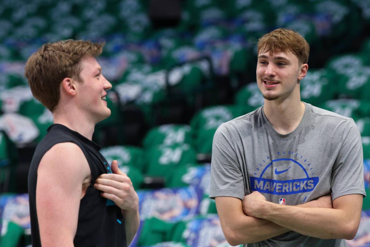  Dallas Mavericks forward Cooper Flagg (right) speaks with Charlotte Hornets guard Kon Knueppel (left) 