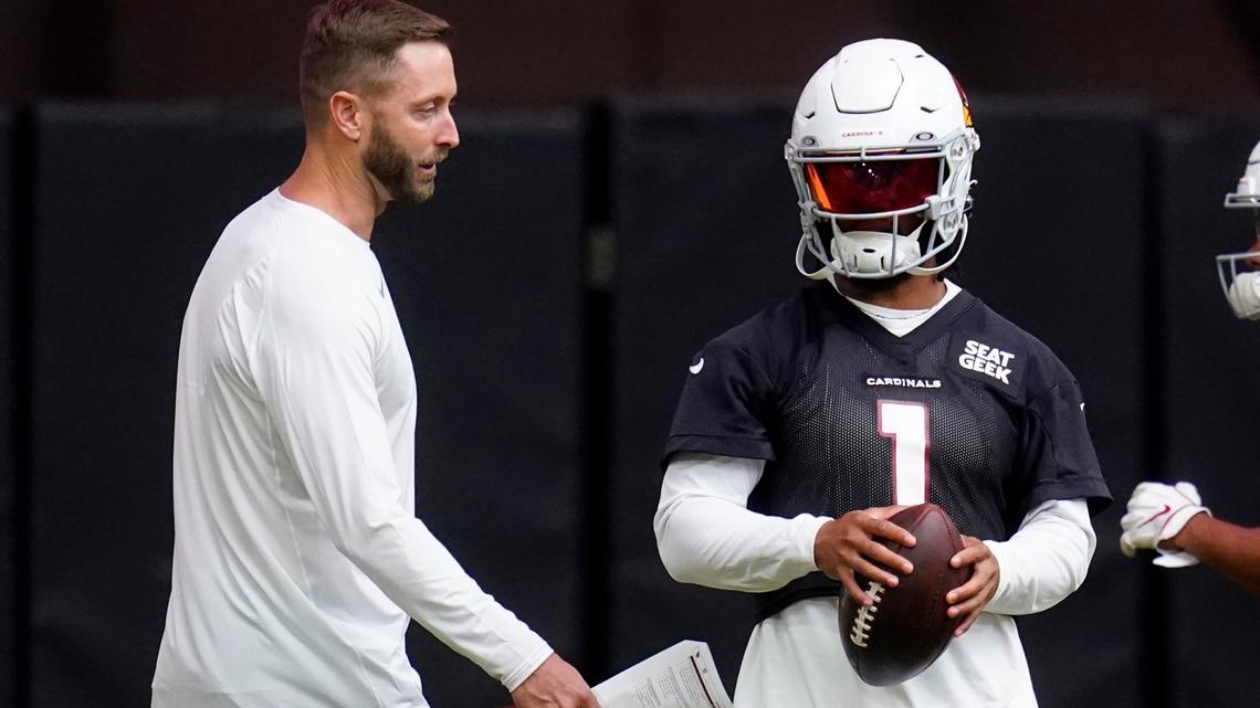 Arizona Cardinals coach Kliff Kingsbury, left, talks with quarterback Kyler Murray during passing drills at the NFL football team’s training camp Wednesday, July 27, 2022, in Glendale, Ariz. (AP Photo/Ross D. Franklin)