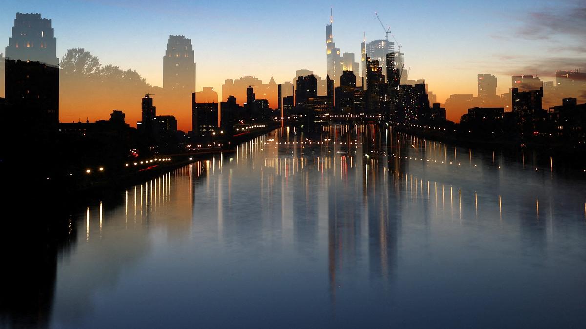 The sun sets behind the skyline during a warm autumn evening in Frankfurt, Germany, October 1, 2023. Picture is taken with long time exposure and using the zoom. REUTERS/Kai Pfaffenbach