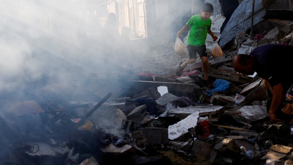 A Palestinian boy walks amidst debris at the site of an Israeli strike on a house that was pre-warned by the Israeli military to evacuate before the strike was carried out late on Saturday, in Deir al-Balah, in the central Gaza Strip, May 24, 2026. REUTERS/Mahmoud Issa