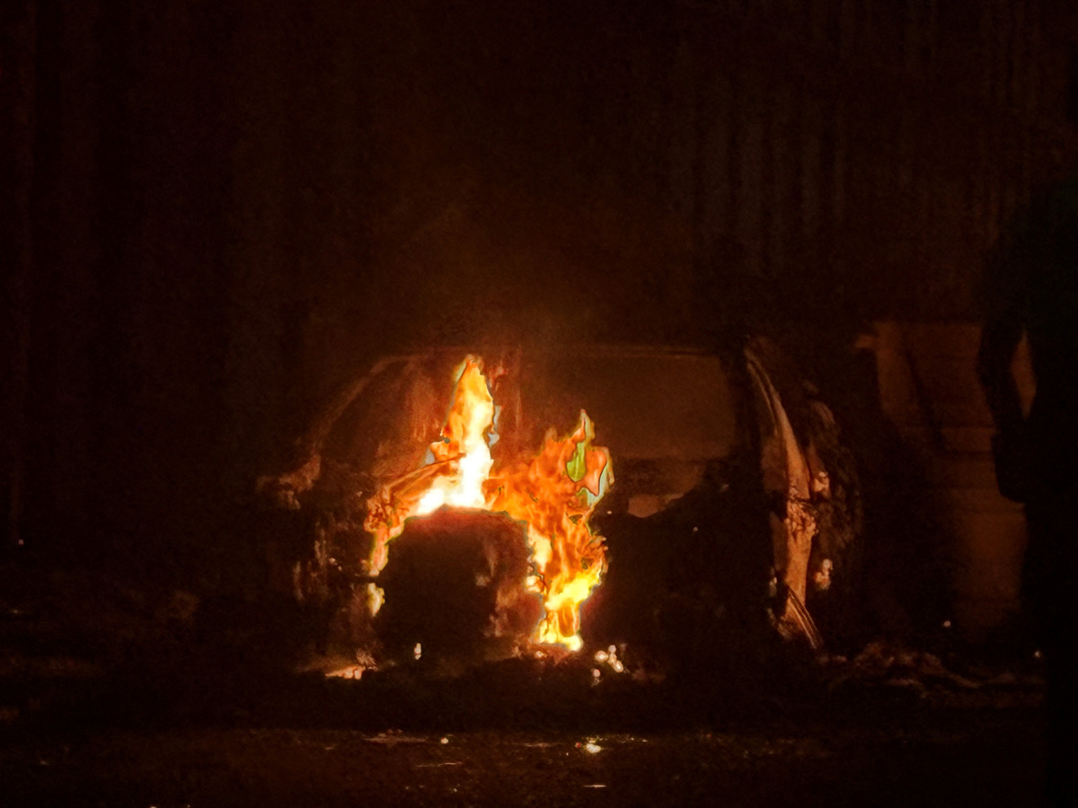 A car burns in east Belfast, during a protest after a knife attack on June 8 left a man seriously injured and prompted police to declare a critical incident, in Belfast, Northern Ireland, June 9, 2026. Picture taken wih a phone. REUTERS/Isabel Infantes