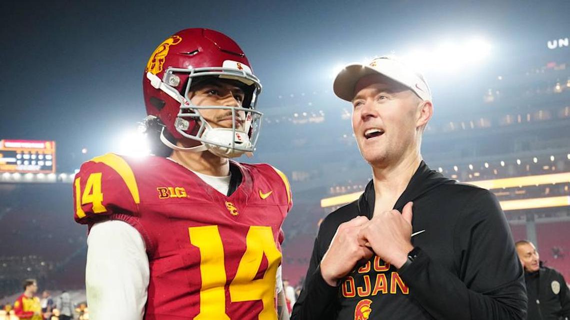  Nov 29, 2025; Los Angeles, California, USA; Southern California Trojans quarterback Jayden Maiava (14) and head coach Lincoln Riley react after the game against the UCLA Bruins at United Airlines Field at Los Angeles Memorial Coliseum. Mandatory Credit: Kirby Lee-Imagn Images | Kirby Lee-Imagn Images 