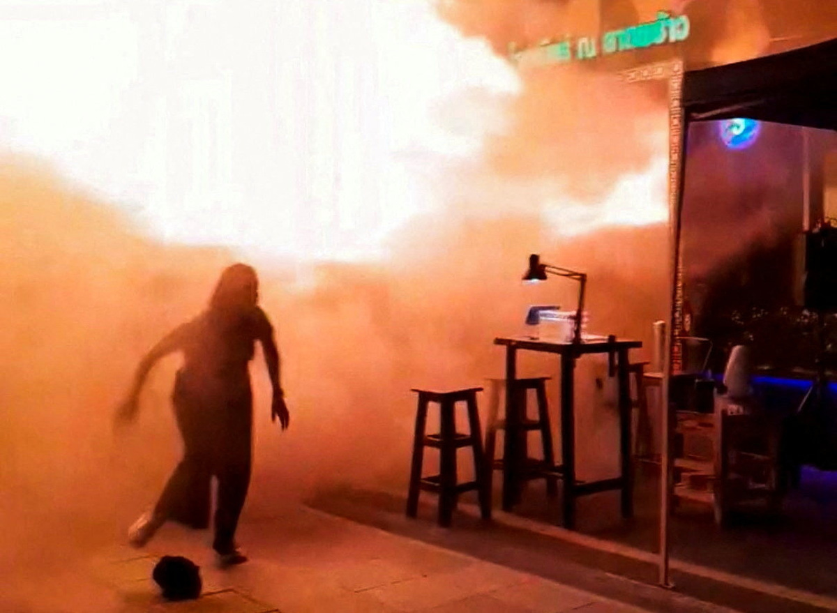 People run as flames rise at a pub in Bangkok, Thailand, in this screengrab taken from a social media video released on July 13, 2026. txng.di.kwa.deim.hi.di via Facebook/via REUTERS