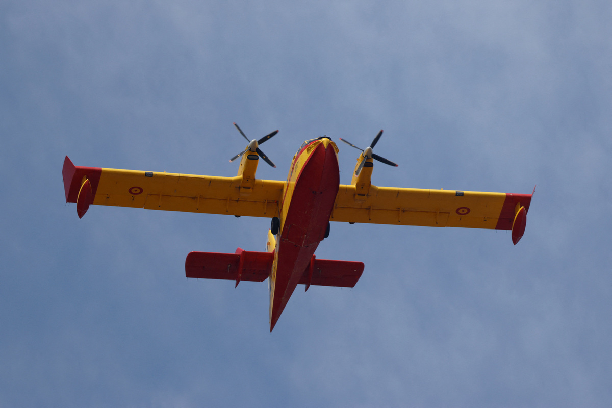 An aircraft flies above wildfires affecting Almeria province, in Los Gallardos, Spain, July 11, 2026. REUTERS/Jon Nazca