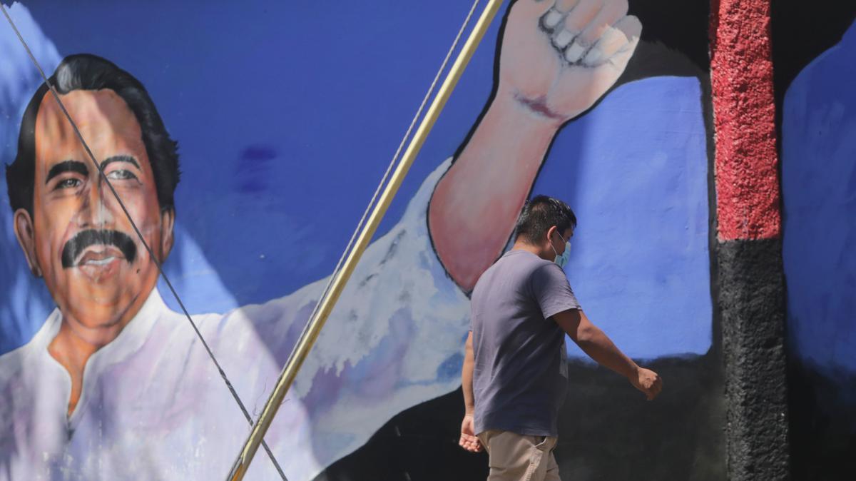 A man walks past a mural of Nicaraguan President Daniel Ortega during elections in Managua, Nicaragua, on Nov. 7.