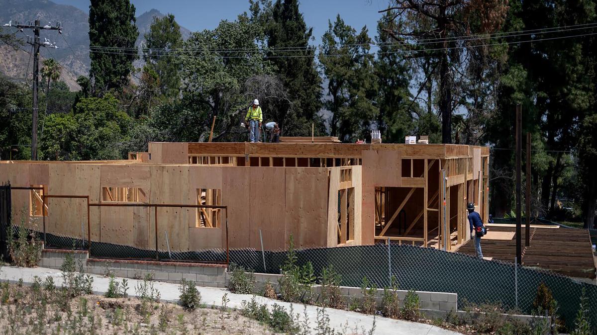 People work on a home under construction along Palm Street on Thursday, April 30, 2026, in Altadena, California. A feared wave of investors bringing unwanted change to Altadena and Palisades hasn't come to pass, as rebuilding continues from the Eaton and Palisades fires in 2025. (Eric Thayer/Los Angeles Times/TNS)