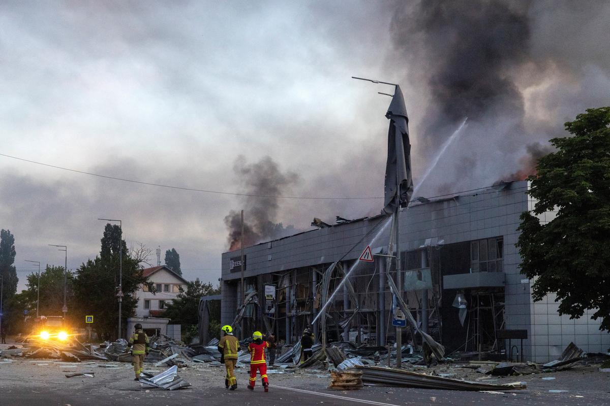 Emergency workers respond to a fire in a car dealership that was struck during overnight Russian missile and drone attacks, amid Russia's attack on Ukraine, in Kyiv, Ukraine, June 2, 2026. REUTERS/Thomas Peter