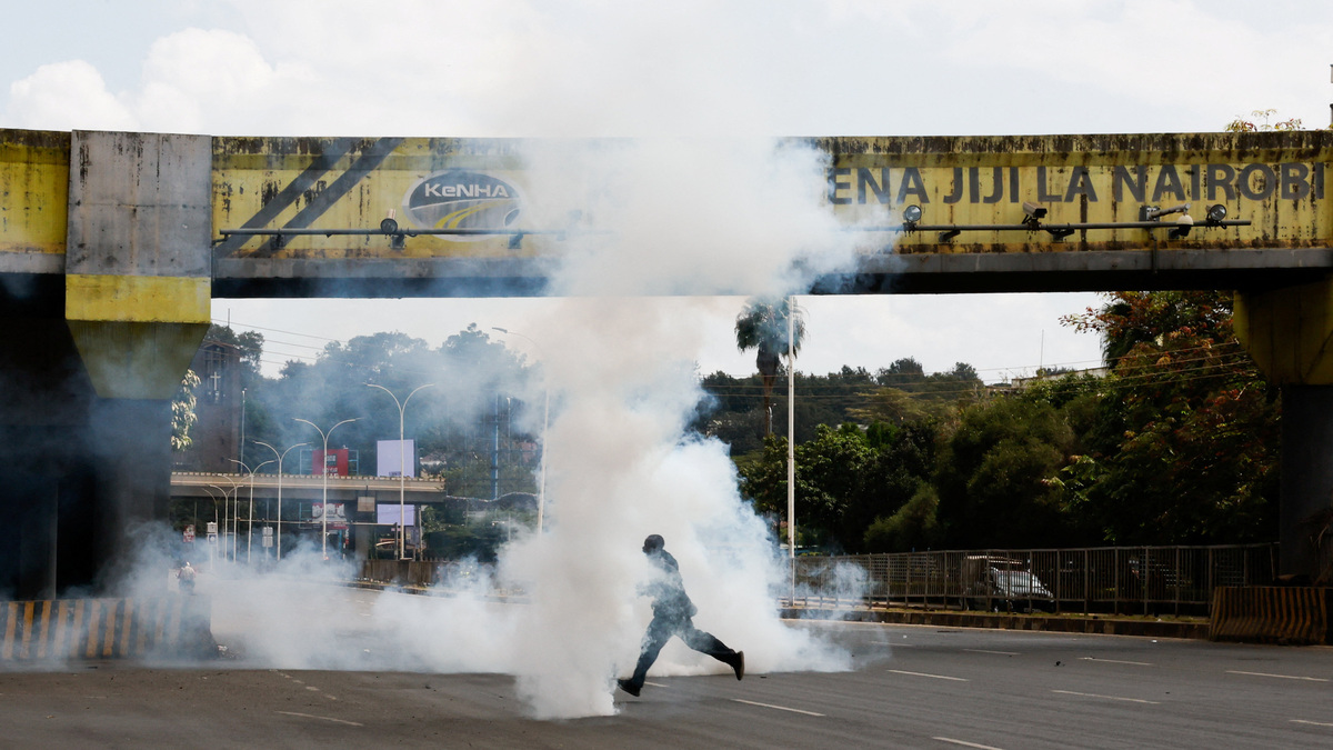 A man runs  through tear gas used by police to disperse protesters during demonstrations to mark the second anniversary of the deadly 2024 anti-government protests, in Nairobi, Kenya, June 25, 2026. REUTERS/Monicah Mwangi